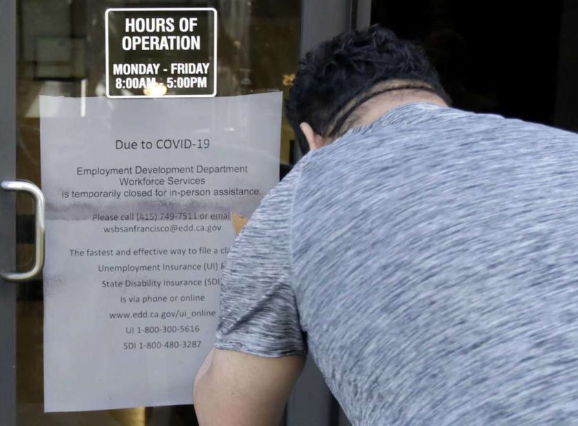 man in front of store closed during covid